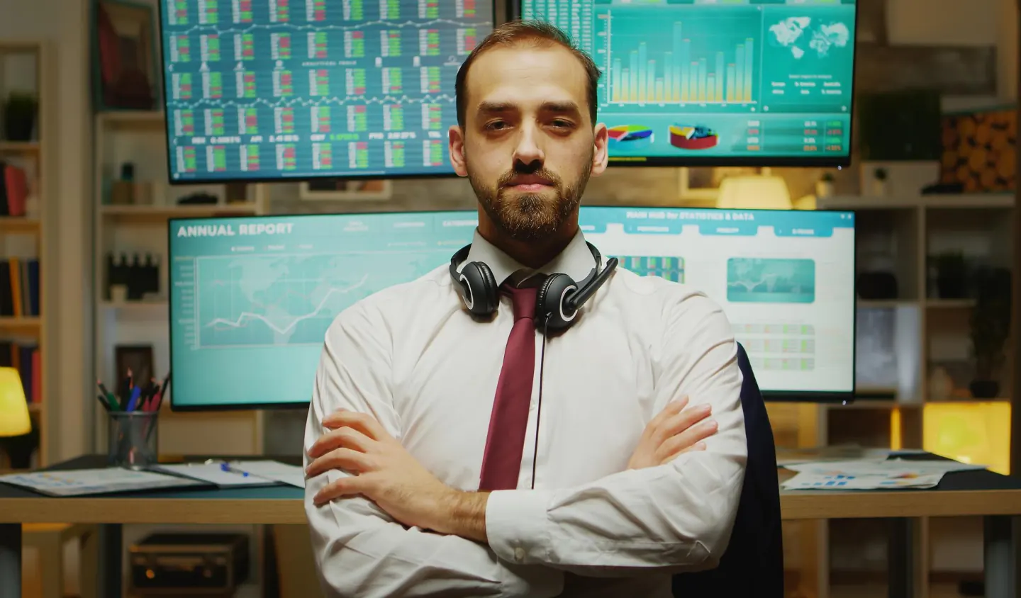 Professional at a workstation with data dashboards